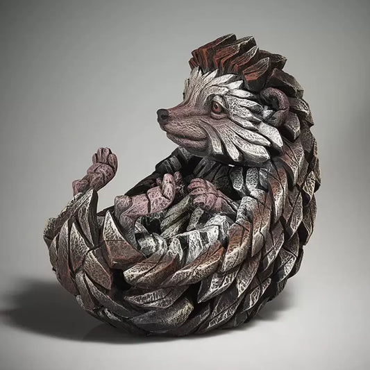 A textured and painted curled sitting hedgehog sculpture side view