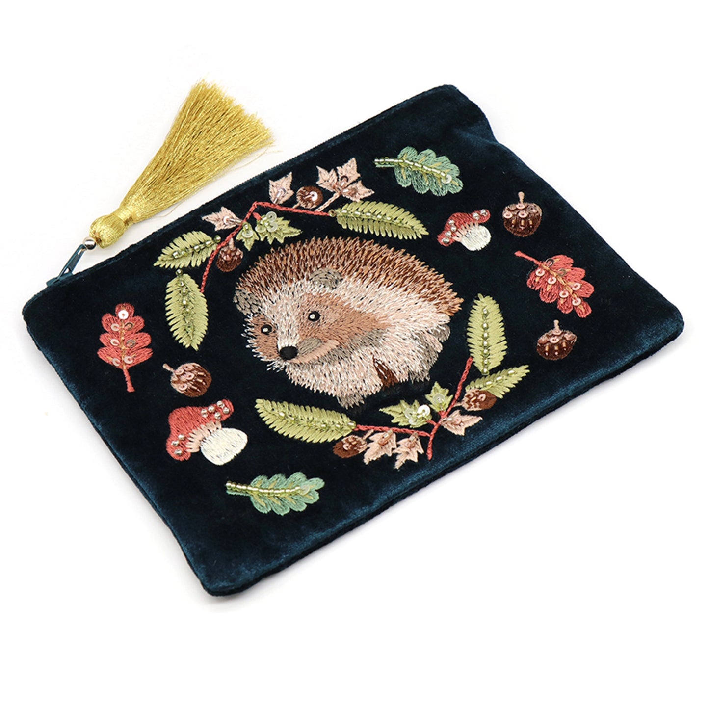 A dark teal velvet pouch with a tassel on the zip and an embroidered and beaded hedgehog design