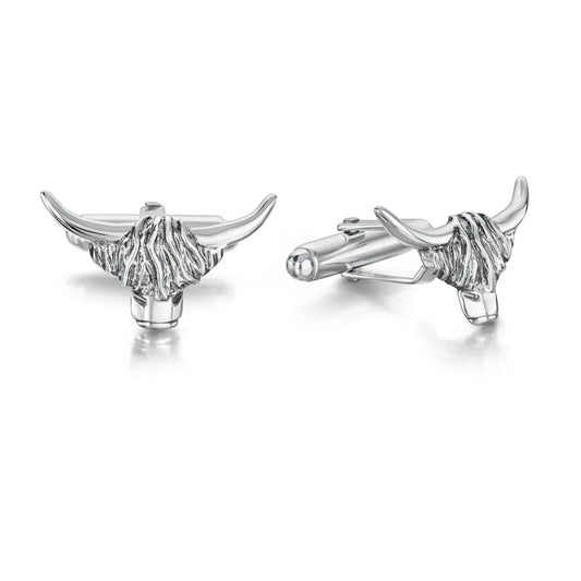 A pair of silver cufflinks shaped like Highland cow heads with simple T-bar clasps and oxidised details