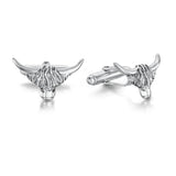 A pair of silver cufflinks shaped like Highland cow heads with simple T-bar clasps and oxidised details