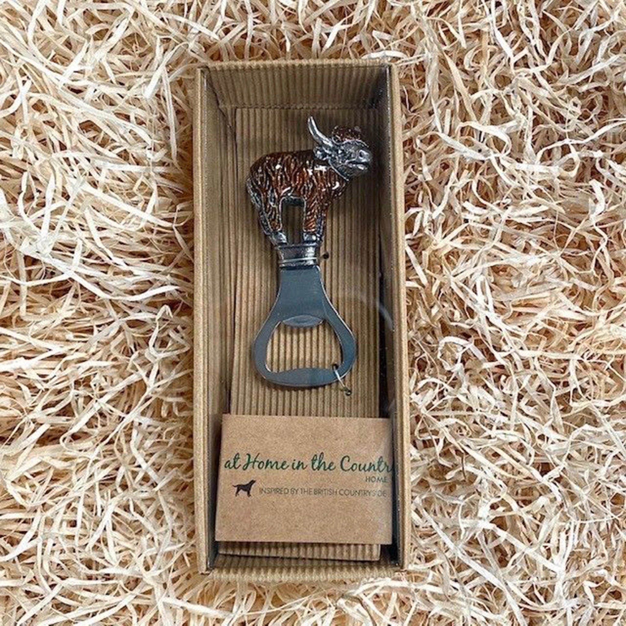An enamelled Highland cow bottle opener in box