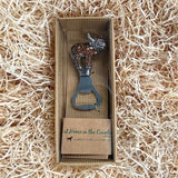 An enamelled Highland cow bottle opener in box