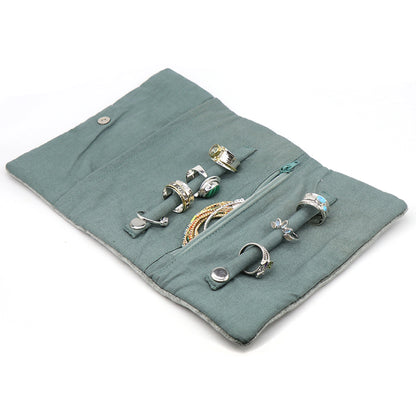 Open seafoam green velvet jewellery roll with two snap ring rolls and a zip pocket