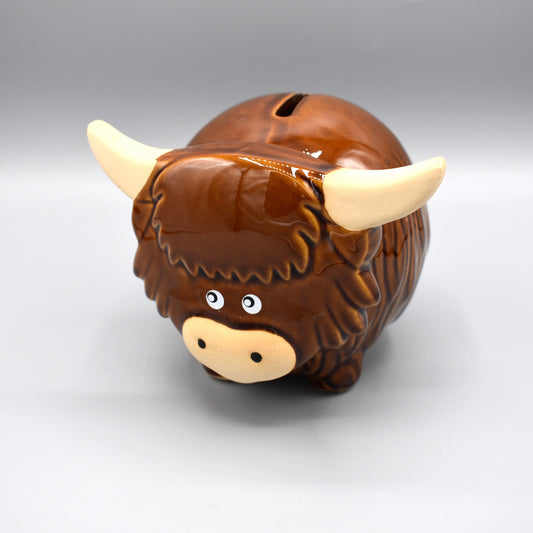 A little round painted Highland cow money pot