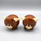 A pair of salt & pepper table shakers shaped like Highland Cows