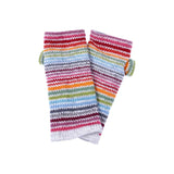 A pair of wool knitted wrist warmers with thin rainbow stripes on white
