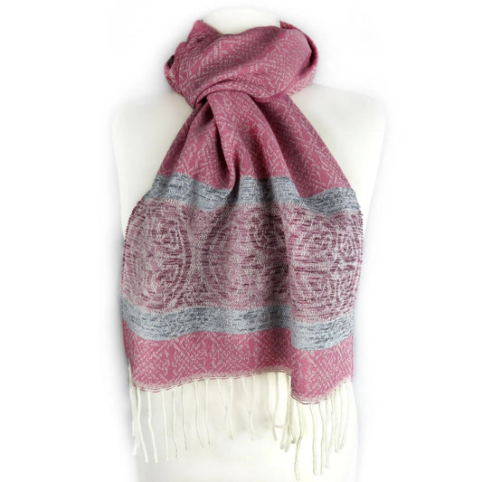 Pink scarf with celtic knot designs and a complimenting border with darker pink and blue and a white tassel trim on bust