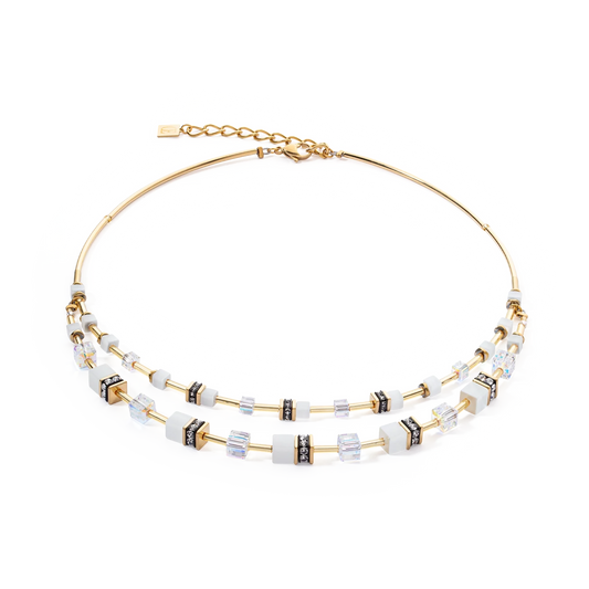 A double layer gold steel necklace with white cube beads