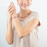 Model wearing a bright pink beaded stainless steel necklace