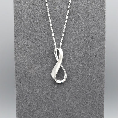 A silver matt & shiny infinity symbol shaped pendant