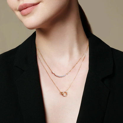 Model wearing interlinked circle gold chain necklace with CZ stones
