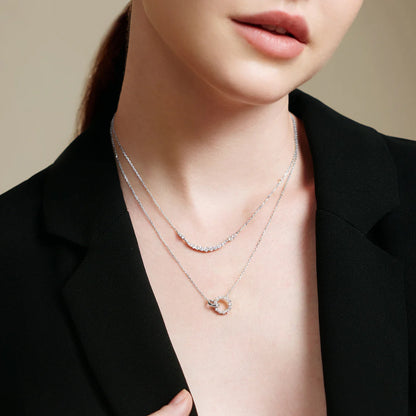 Model wearing interlinked circle silver chain necklace with CZ stones