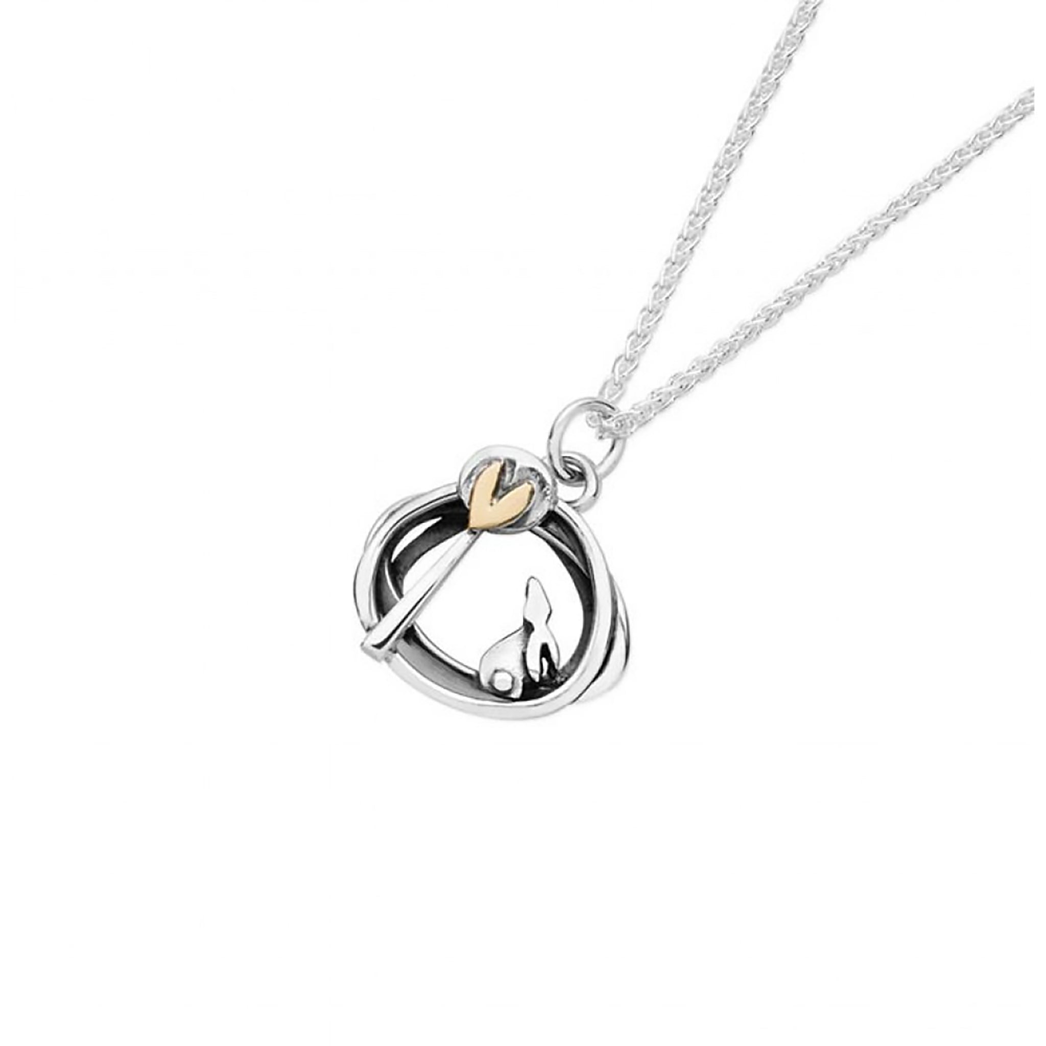 Silver pendant with irregular round shape, a bunny and tree design and a gold heart detail on silver chain