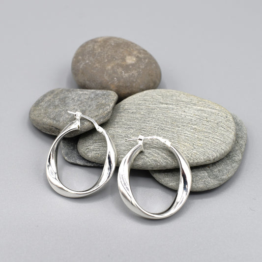 A pair of elegant twisting irregular oval hoop earrings