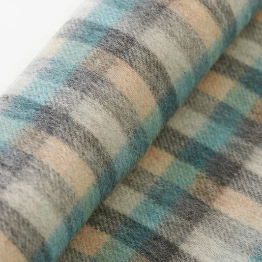 A check patterned tartan wool scarf in blue and beige close up