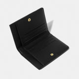 Open black purse featuring a gold snap button and card slots