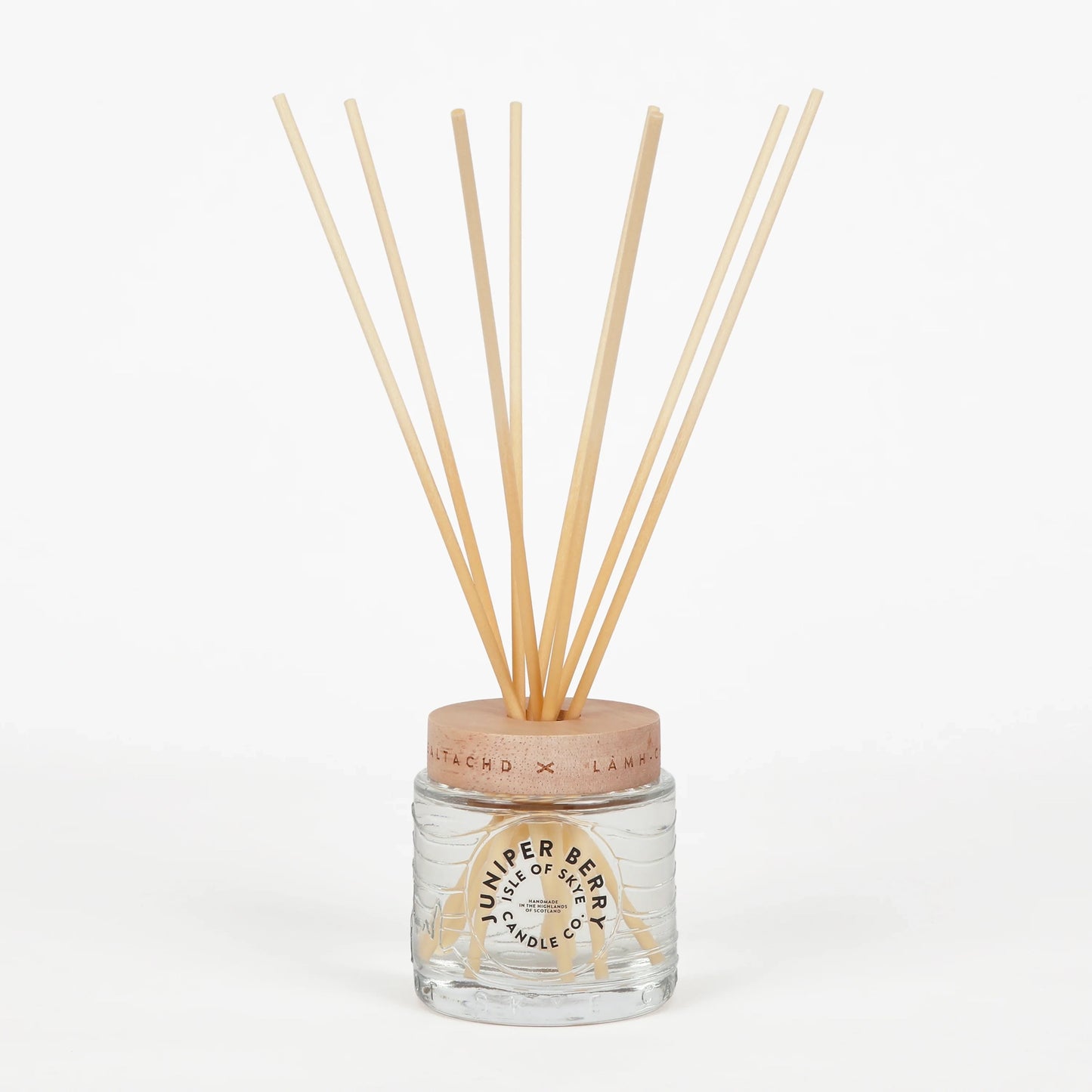 Juniper berry scented reed diffuser in glass container
