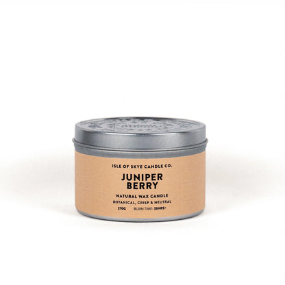 A travel tin candle in the scent juniper berry