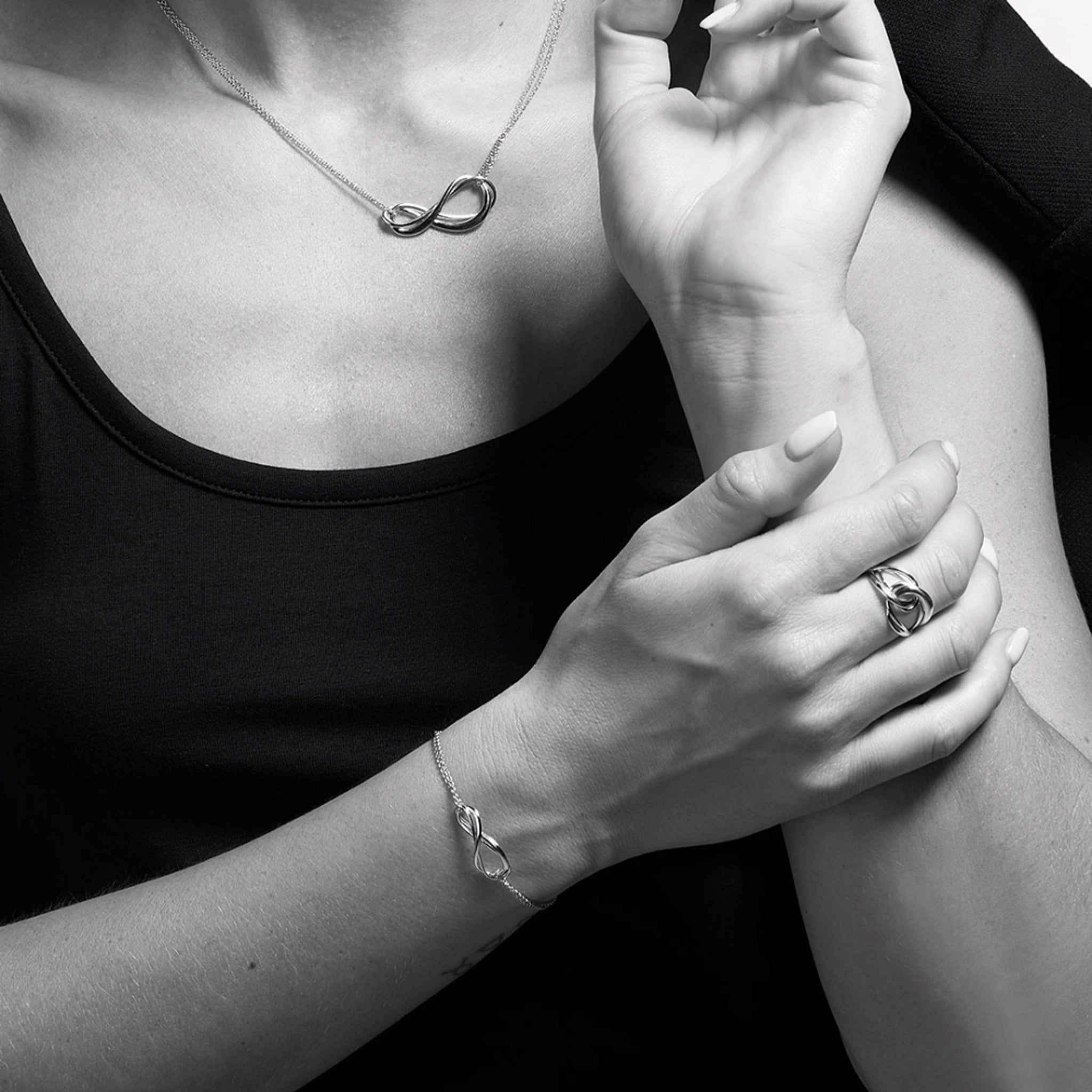 Model wearing a silver double strand infinity symbol bracelet