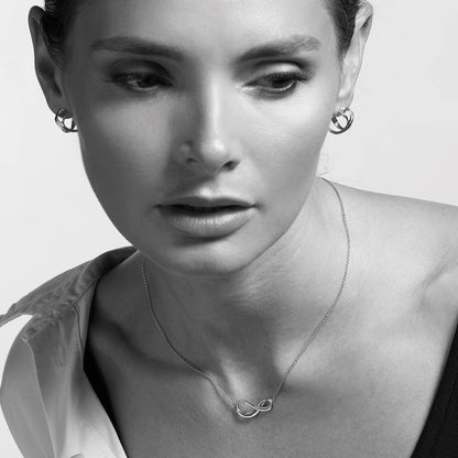 Model wearing a silver double strand infinity symbol necklace