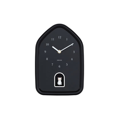 House shaped black cuckoo clock with white hands and white cat