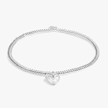 Silver bracelet with an asymmetrical heart charm set with a lab grown diamond