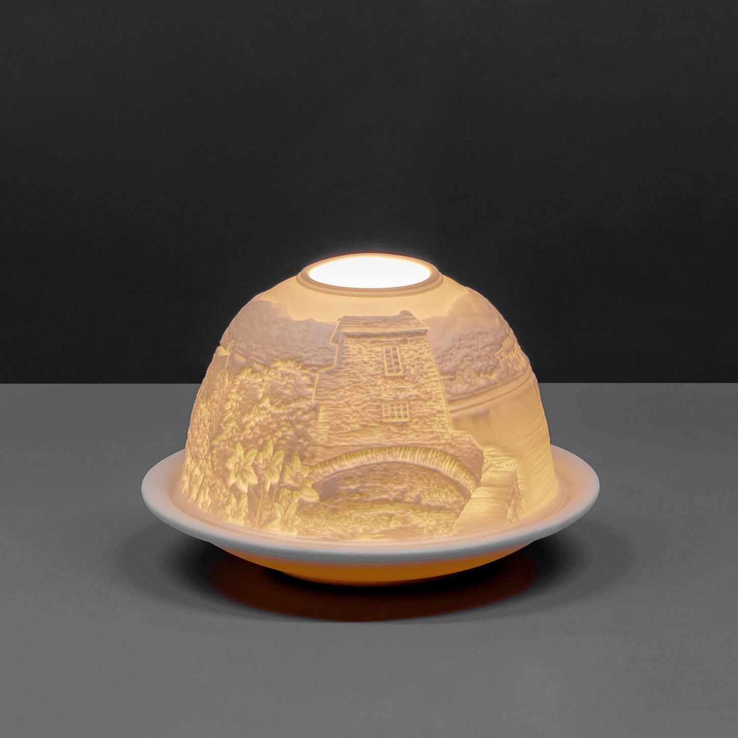 White porcelain tall dome candle holder with engraved Cumbria Lake District scene lit up 2