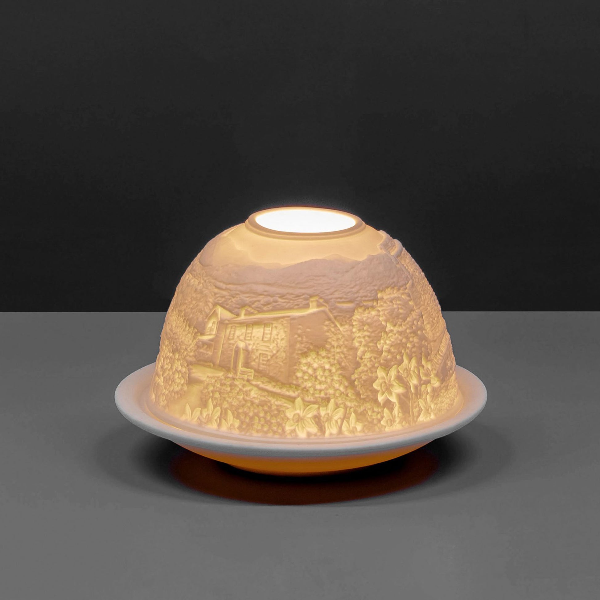 White porcelain tall dome candle holder with engraved Cumbria Lake District scene lit up 3