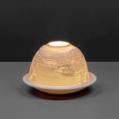 White porcelain tall dome candle holder with engraved Cumbria Lake District scene lit up 