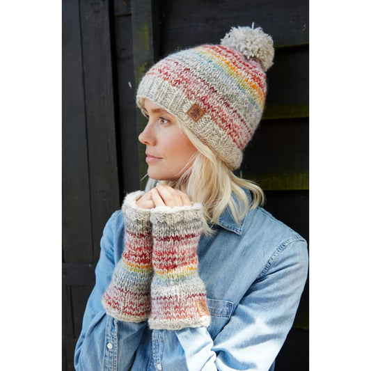 Model wearing a pair of knitted handwarmers in light grey with thin multicoloured stripes.