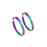 A pair of large flat hoop earrings in a rainbow ombre