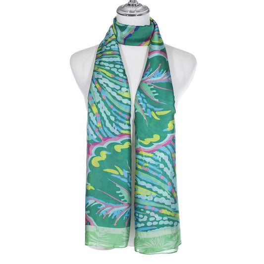 A scarf with a brightly coloured leaf print pattern in pink, blue, yellow and green,