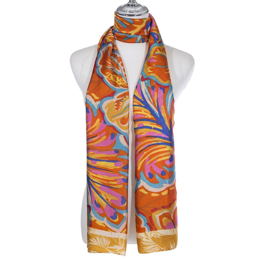 A scarf with a bright leaf pattern in blue, pink and orange