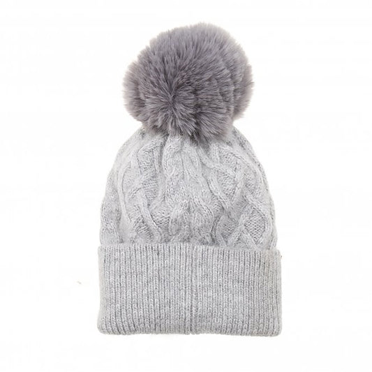 A simple light grey cable knit hat with large fluffy pompom
