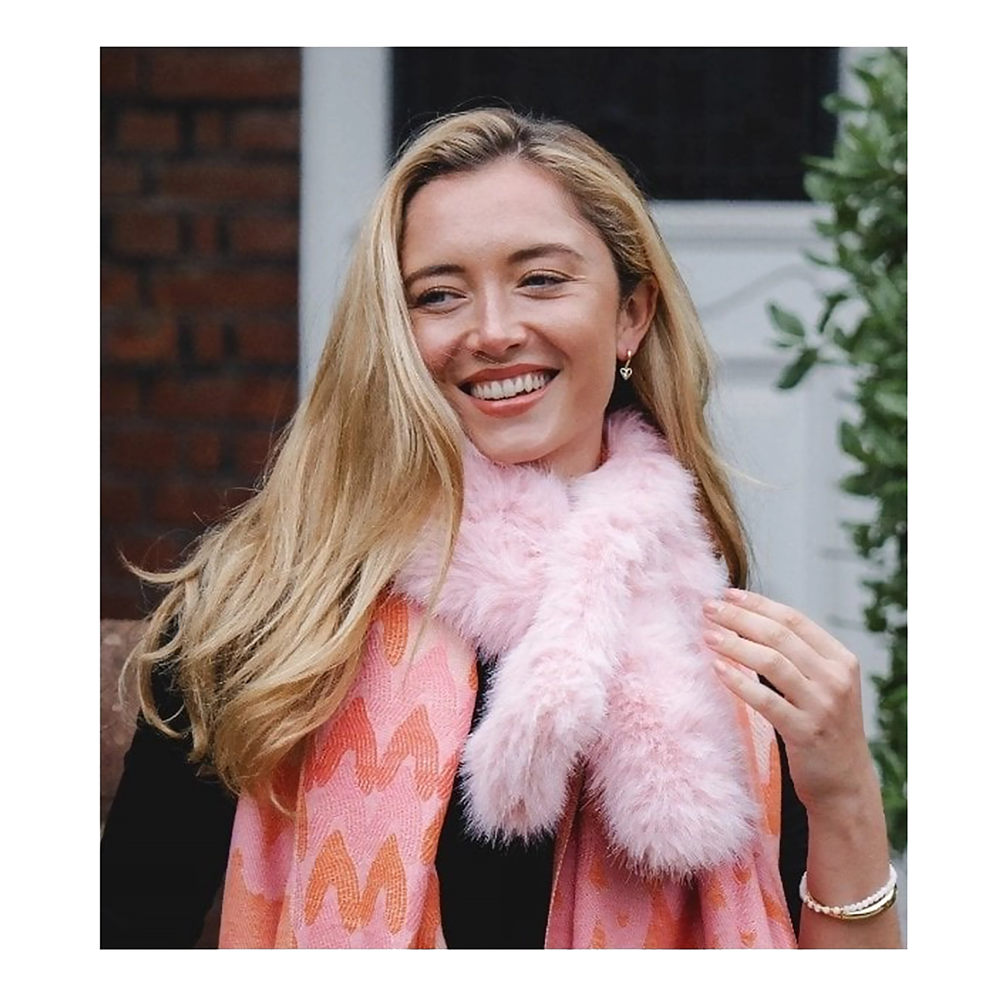 Model wearing a light pink coloured faux fur pull through scarf