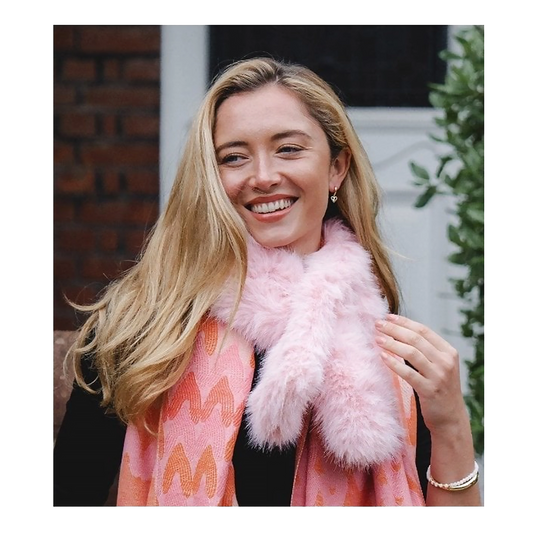 Model wearing a light pink coloured faux fur pull through scarf