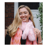 Model wearing a light pink coloured faux fur pull through scarf