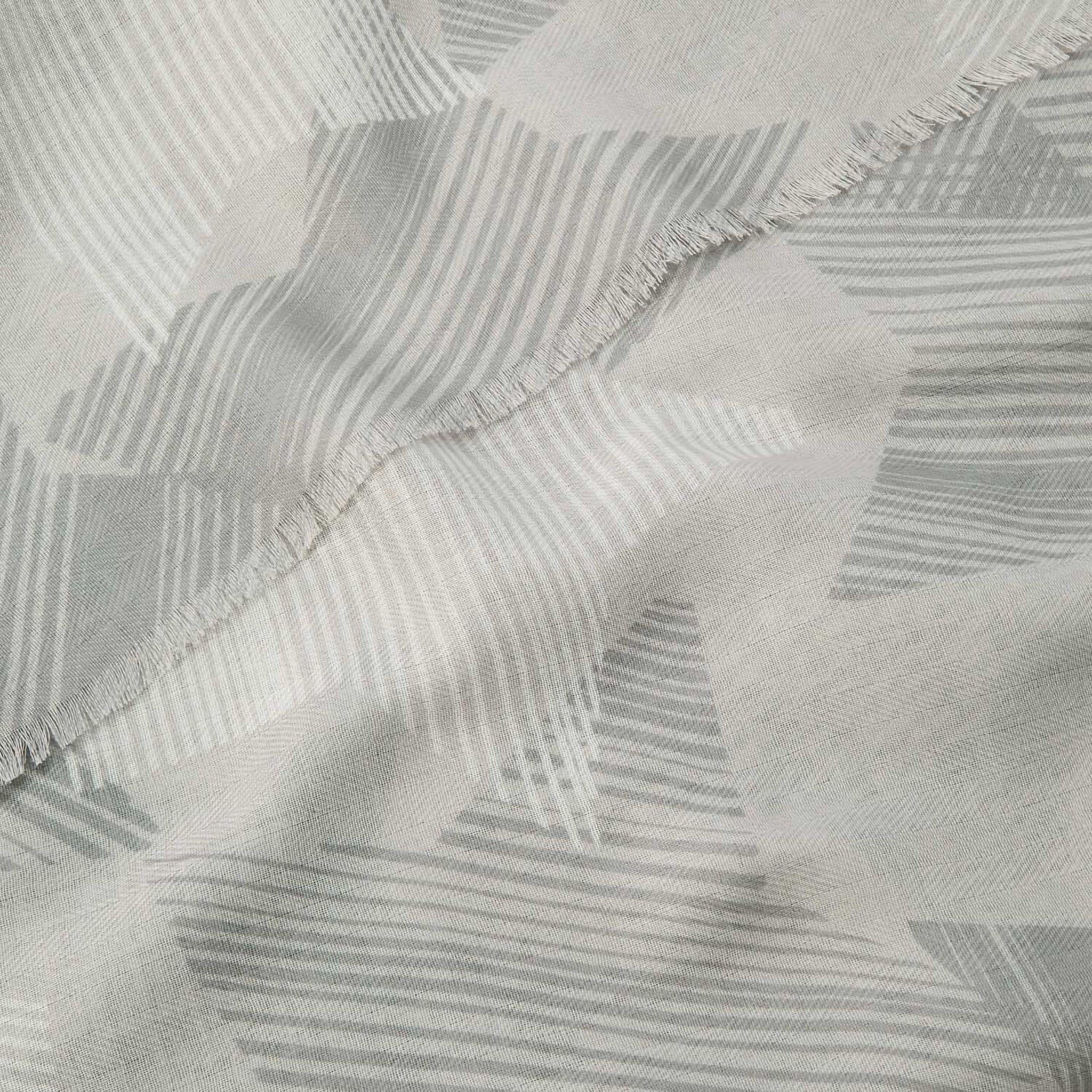 Detailed zoom of a scarf featuring sketch line star pattern in grey and white