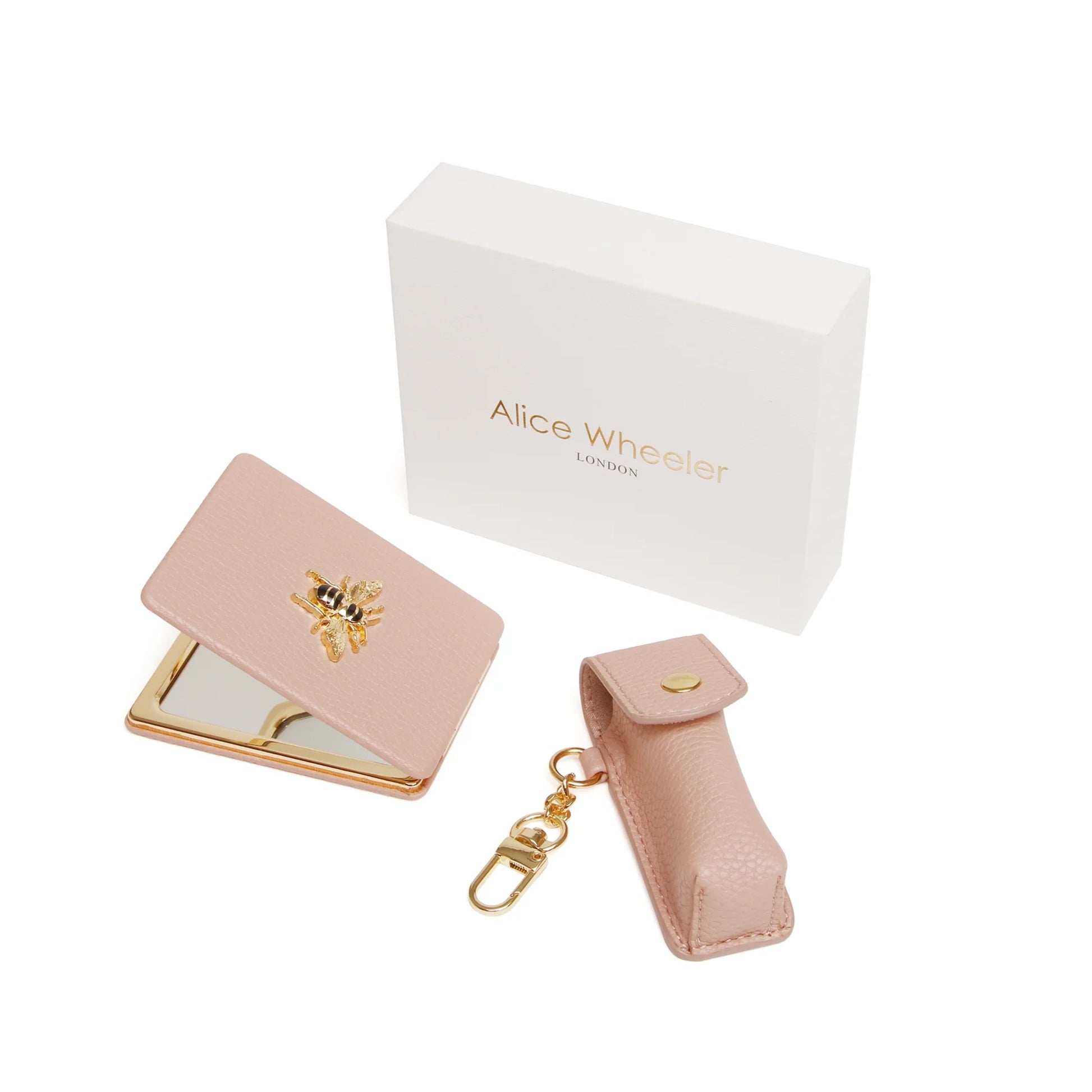Gift set with oblong compact mirror with bee emblem and a lipstick holder in pink faux leather 