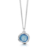 Small silver pendant on chain in an irregular, organic shape with subtle texture and blue enamelled centre