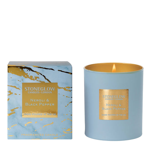 A powder blue and gold tumbler candle with matching marble pattern box