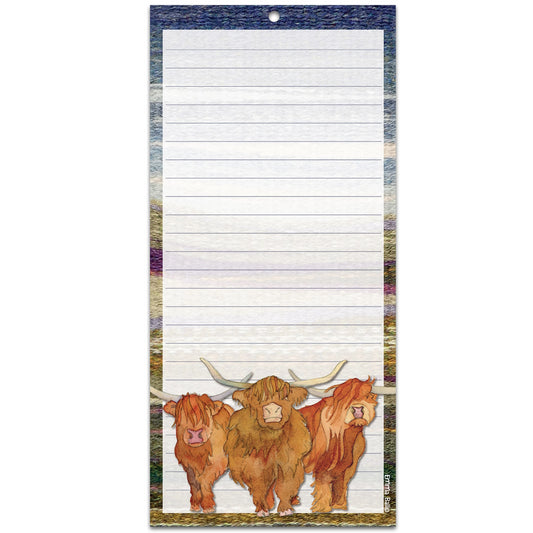 A long notepad featuring an illustration of Highland cows