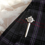 Silver kilt pin with sword shape and round centre with detailed celtic knot on wedding kilt