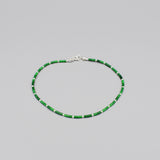 A beaded anklet with cylindrical green malachite and silver ball spacers