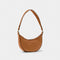 A crescent shaped shoulder bag in brown PU with contrasting black colour wax piping