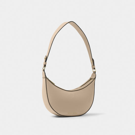 A crescent shaped shoulder bag in taupe PU with contrasting black colour wax piping