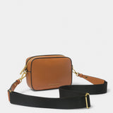 A brown cross-body bag with contrast wax piping in black