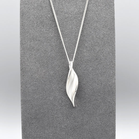 A matt and shiny silver marquis twist shape pendant on silver chain