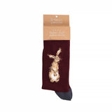 A folded pair of dark red socks with grey heels and a hare