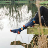 Model wearing a pair of navy socks with orange heels and a kingfisher bird